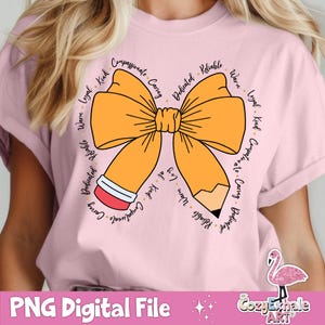 May include: A pink t-shirt featuring a yellow bow and a pencil design. The bow and pencil are encircled by words describing positive character traits, such as "compassionate", "caring", "reliable", and "loyal".