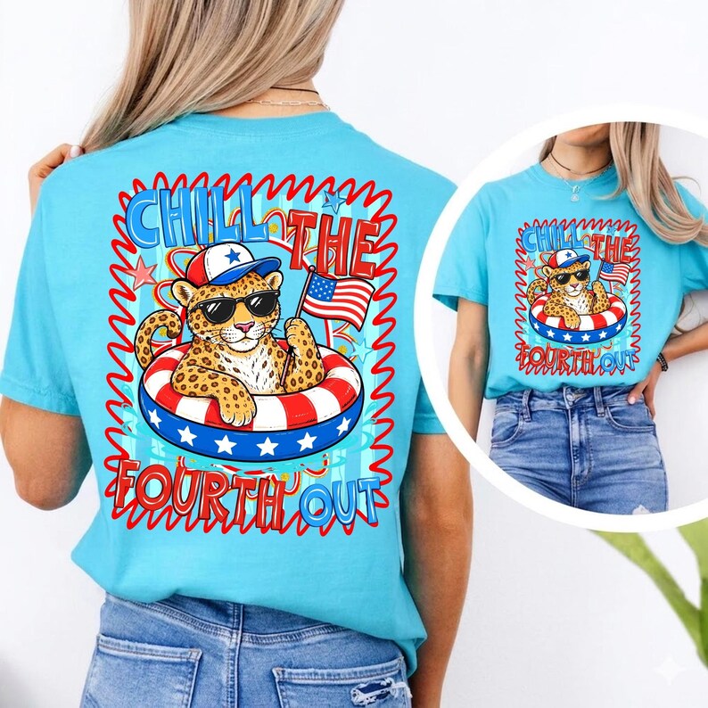 Op de afbeelding: Lichtblauw T-shirt met een afbeelding van een luipaard met een zonnebril en een patriottische hoed, drijvend in een rood, wit en blauw zwemband. De tekst "Chill the Fourth Out" wordt weergegeven in een golvend lettertype.