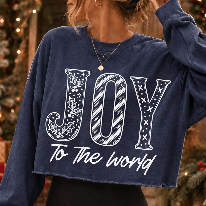 'JOY To The World' Christmas design showcased on a dark green t-shirt