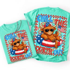 May include: Two turquoise t-shirts with a graphic of a Highland cow wearing sunglasses and a patriotic hat, floating in a red, white, and blue inner tube. The text reads "Chill the Fourth Out."