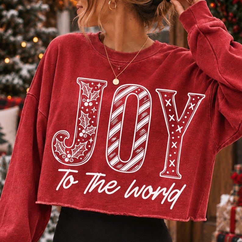 Festive 'JOY To The World' PNG design on a black sweatshirt, perfect for holiday apparel