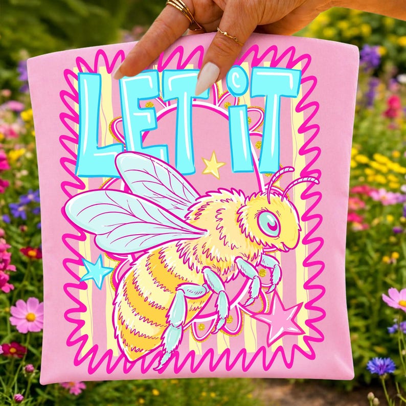 'Let It Bee Positivity' Preppy Striped Bee PNG Sublimation Design on a pastel t-shirt mockup, showcasing vibrant colors.