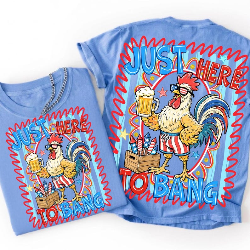 May include: Two light blue t-shirts with a rooster graphic. The rooster wears sunglasses and striped shorts, holding a beer and standing near a crate of fireworks. Text reads "JUST HERE TO BANG" in red and blue.