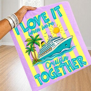 May include: A rectangular, lavender blanket with yellow stripes and the text "I LOVE IT when we're Cruisin' TOGETHER." The blanket features a cartoon cruise ship, palm trees, a sun, and birds.