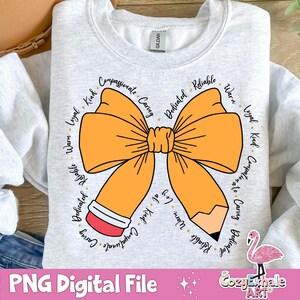 May include: A grey sweatshirt featuring a large orange bow and a pencil design. The bow is encircled by words describing positive character traits, such as "kind", "loyal", "caring", and "dedicated".