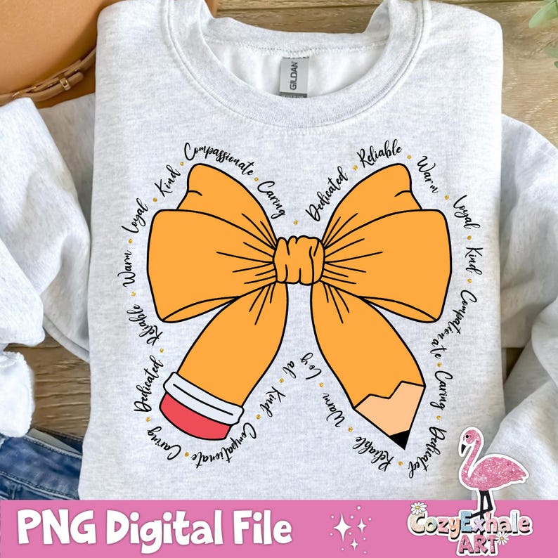 May include: A grey sweatshirt featuring a large orange bow and a pencil design. The bow is encircled by words describing positive character traits, such as "kind", "loyal", "caring", and "dedicated".