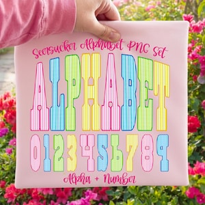 May include: A pink background with the text "Seersucker Alphabet PNG set" in pink script. The word "ALPHABET" is in large, colourful, striped letters. Below are the numbers 0-9, also in colourful stripes. The text "Alpha + Number" is at the bottom.