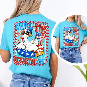 May include: A light blue t-shirt featuring a cartoon goose wearing sunglasses and a patriotic hat, floating in a red, white, and blue inner tube. The shirt has the words "Chill the Fourth Out" in a wavy font.
