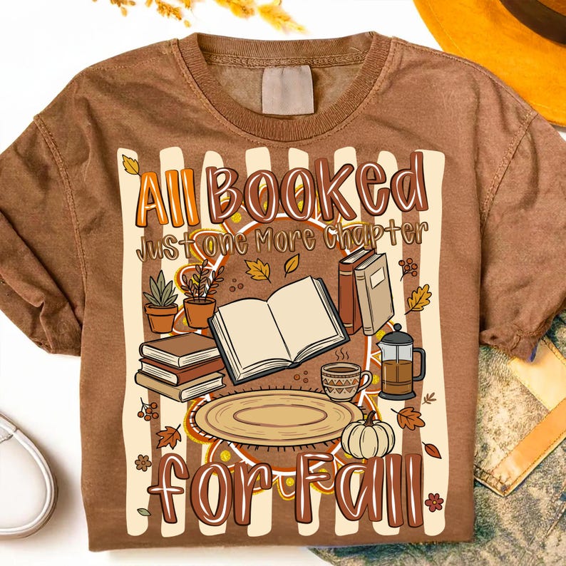 Mockup of a white t-shirt featuring the 'All Booked For Fall' cozy book lover sublimation design with autumn leaves and pumpkins.