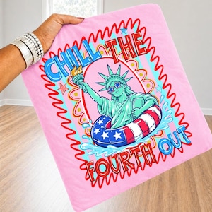 May include: A pink blanket featuring a graphic of the Statue of Liberty wearing sunglasses and a patriotic inner tube. The text "CHILL THE FOURTH OUT" is displayed in blue and red. The design is surrounded by a red wavy border.