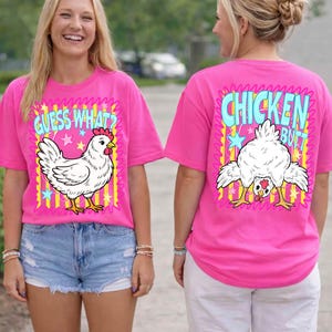 May include: Pink t-shirts with chicken-themed graphics. One shirt features a white chicken with the text "Guess What?" and the other displays a chicken's rear with the text "Chicken Butt."