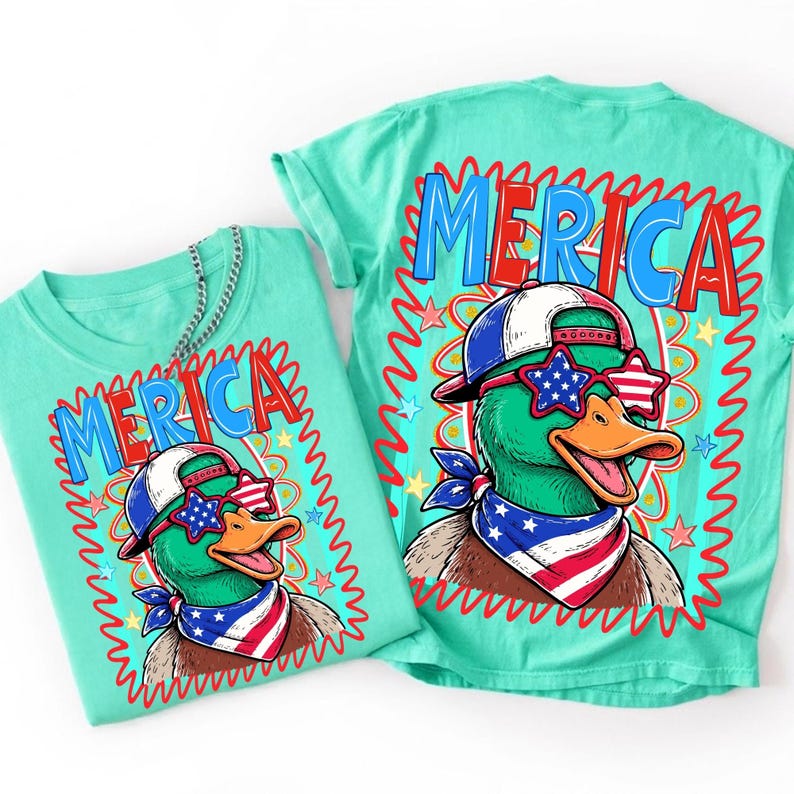 May include: Two turquoise t-shirts with a cartoon duck wearing sunglasses, a bandana, and a baseball cap. The shirts have the word "MERICA" in red and blue. The duck is green with an orange beak.