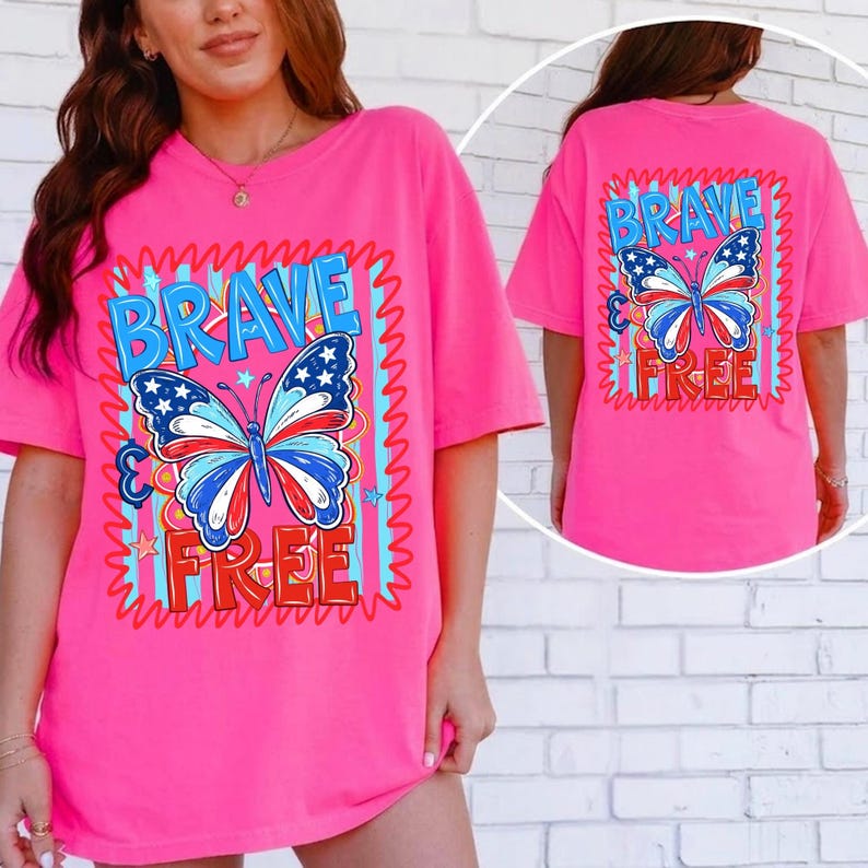May include: A vibrant pink t-shirt with a butterfly design in red, white, and blue. The words "BRAVE" and "FREE" are printed above and below the butterfly. The same design is on the back of the shirt.