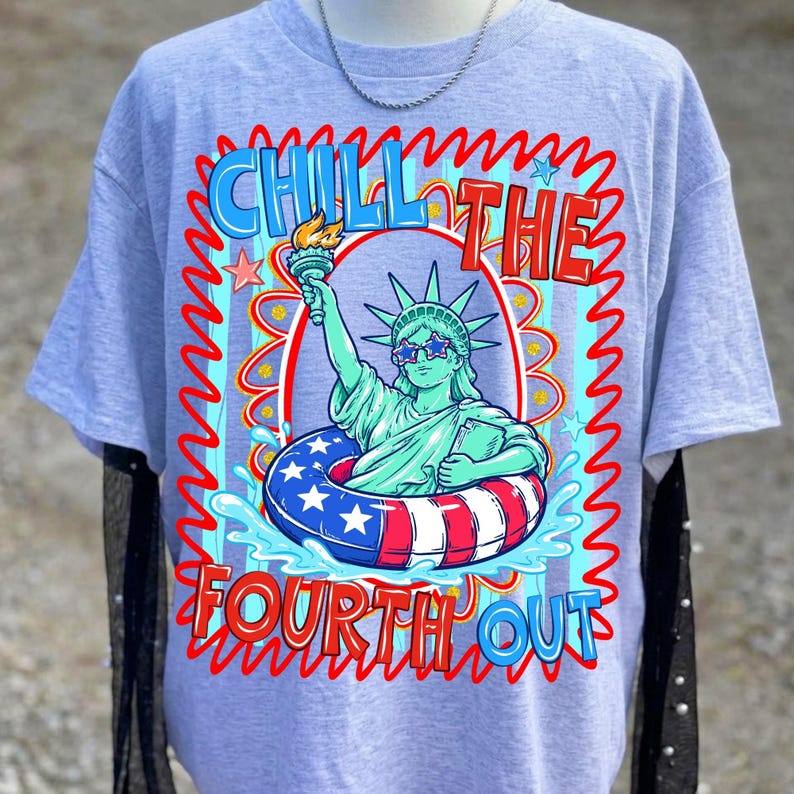 May include: A light gray t-shirt featuring a graphic of the Statue of Liberty wearing star-shaped sunglasses and floating in a red, white, and blue inner tube. The text "CHILL THE FOURTH OUT" is displayed in a wavy font.