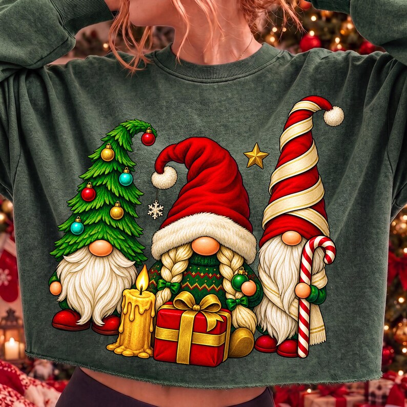 Puede incluir: Una sudadera de manga larga de color verde oscuro con un estampado gr&aacute;fico de tres gnomos. Un gnomo tiene forma de &aacute;rbol de Navidad, otro sostiene una vela amarilla y un regalo rojo, y el tercero lleva un gorro a rayas rojas y blancas con un bast&oacute;n.