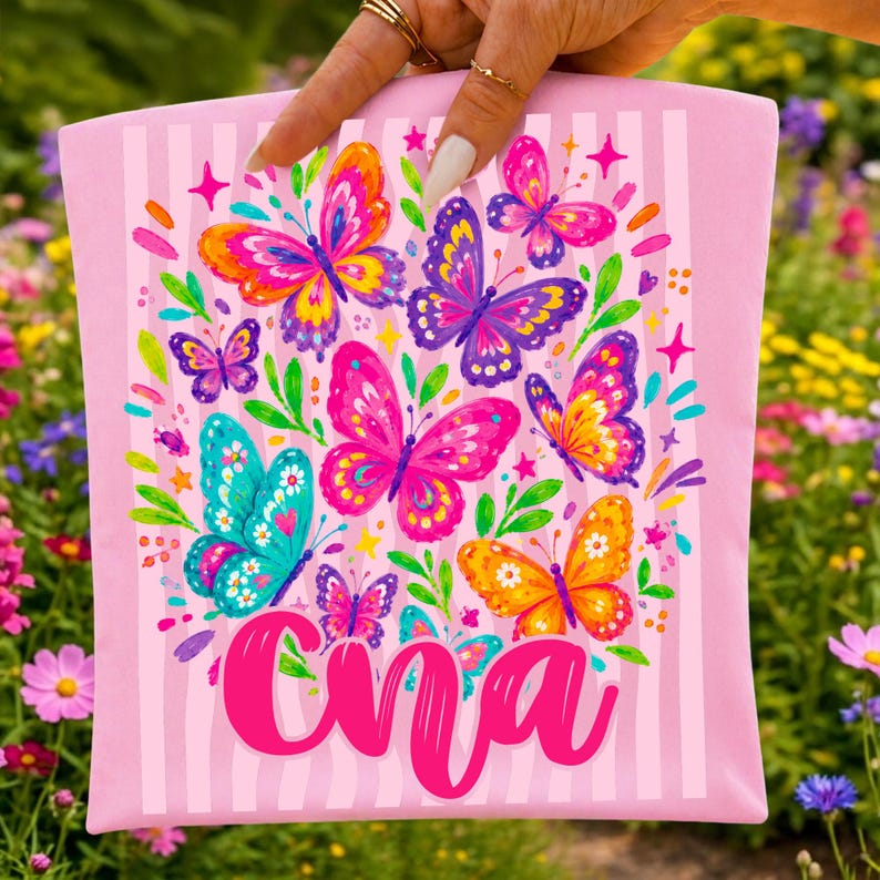May include: A light pink fabric pouch featuring a vertical striped pattern and a colorful graphic print of various butterflies in shades of pink, purple, orange, and teal, with the name "Cna" written in a bold, cursive, bright pink script font.