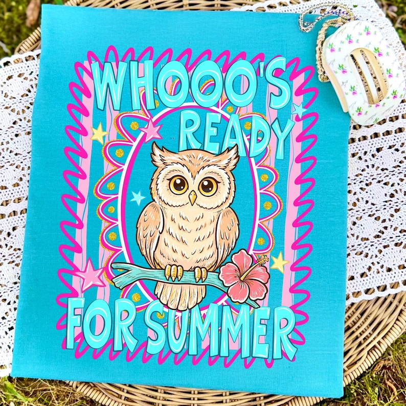 Peut inclure: Une serviette d&eacute;corative rectangulaire turquoise avec le texte "WHOOO'S READY FOR SUMMER" et un dessin de hibou perch&eacute; sur une branche avec une fleur d'hibiscus rose. Le design comprend des accents roses et jaunes.