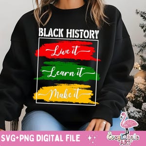 May include: Black sweatshirt with the text "BLACK HISTORY" in white letters. Below the text are three colourful stripes with the text "Live it", "Learn it", and "Make it" in white cursive writing.