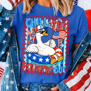 May include: Blue t-shirt with a graphic of a goose wearing sunglasses and a hat, floating in a patriotic inner tube and holding a small American flag. The text "Chill the Fourth Out" is displayed in red and blue.