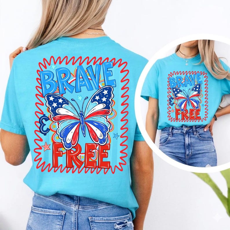 May include: A turquoise t-shirt with a butterfly design in red, white, and blue. The words "BRAVE" and "FREE" are written above and below the butterfly in a red, wavy font. The design is framed by a red, wavy border.