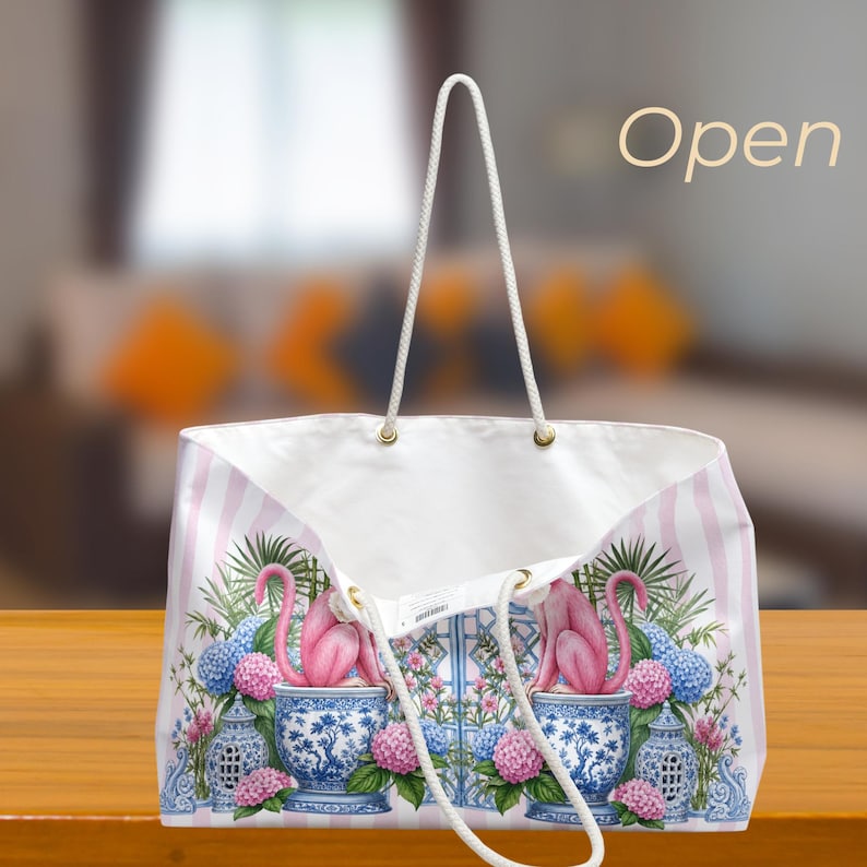 May include: A white tote bag with light pink vertical stripes featuring a graphic print of pink monkeys sitting in blue and white patterned ceramic pots surrounded by blue and pink hydrangea flowers and green foliage. The word Open is visible.