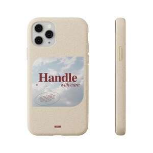 May include: Beige phone case with a sky graphic and the words "Handle with care" in burgundy. The case has a textured surface and a camera cutout. The side view shows a slim profile.