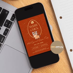 May include: A smartphone displays a digital invitation for a "Red Egg and Ginger Party." The invitation features an egg-shaped design with the name "Avery Chen" and a cartoon character. The background is a reddish-orange color.