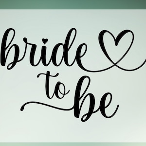 May include: Black and white calligraphy text that reads "bride to be" with a small heart above the word "bride" and a large heart to the right of the text.
