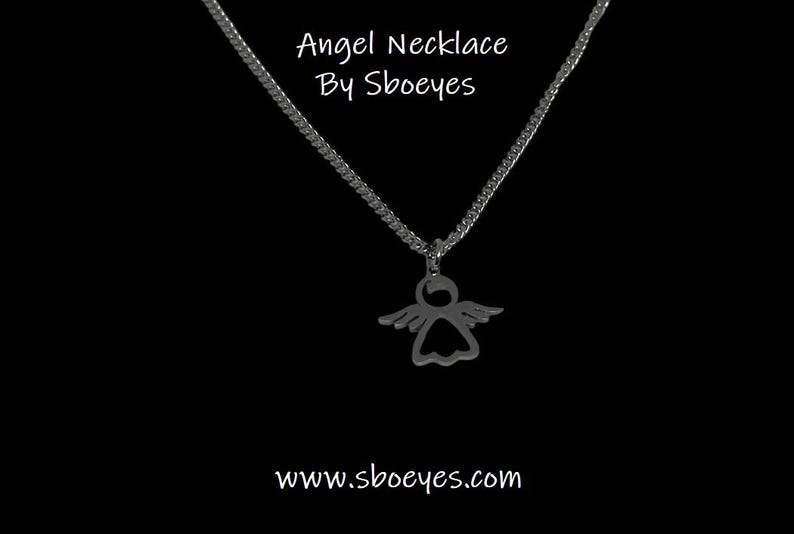 May include: A silver chain necklace with an angel pendant. The pendant is a cutout of an angel with wings. The necklace is on a black background. The text "Angel Necklace By Sboeyes" is above the necklace and the text "www.sboeyes.com" is below the necklace.