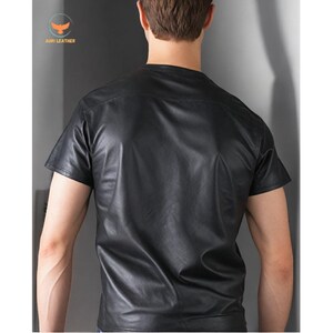 May include: A black leather short-sleeved shirt.