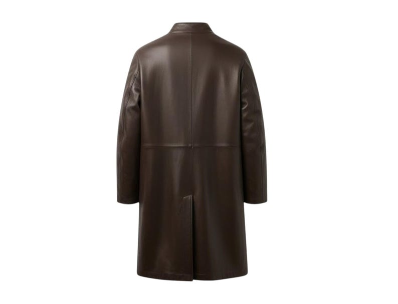 May include: A dark brown leather coat with a classic design. The coat features a notched collar, long sleeves, and a knee-length hem. The back of the coat has a center vent for ease of movement. The coat is made of a smooth, supple leather.