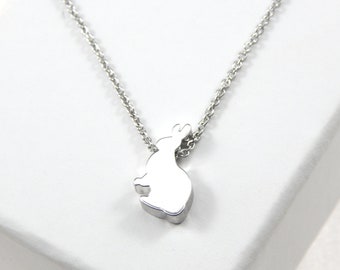 May include: A silver chain necklace with a small, silver rabbit pendant.