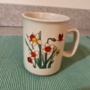 Vintage ceramic mug with flower and butterfly design