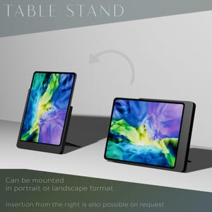 May include: A black tablet stand with a tablet displaying a colorful abstract image. The stand can be mounted in portrait or landscape format. The text "TABLE STAND" is at the top of the image.