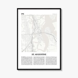 May include: A framed vertical wall art print featuring a light grey map of St. Augustine, Florida, with black street lines and water bodies. The text STA and FLORIDA, USA appear at the top, with ST. AUGUSTINE and descriptive text at the bottom.