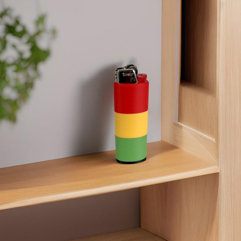 May include: A red, yellow, and green lighter with a silver top. The lighter is sitting on a wooden shelf.