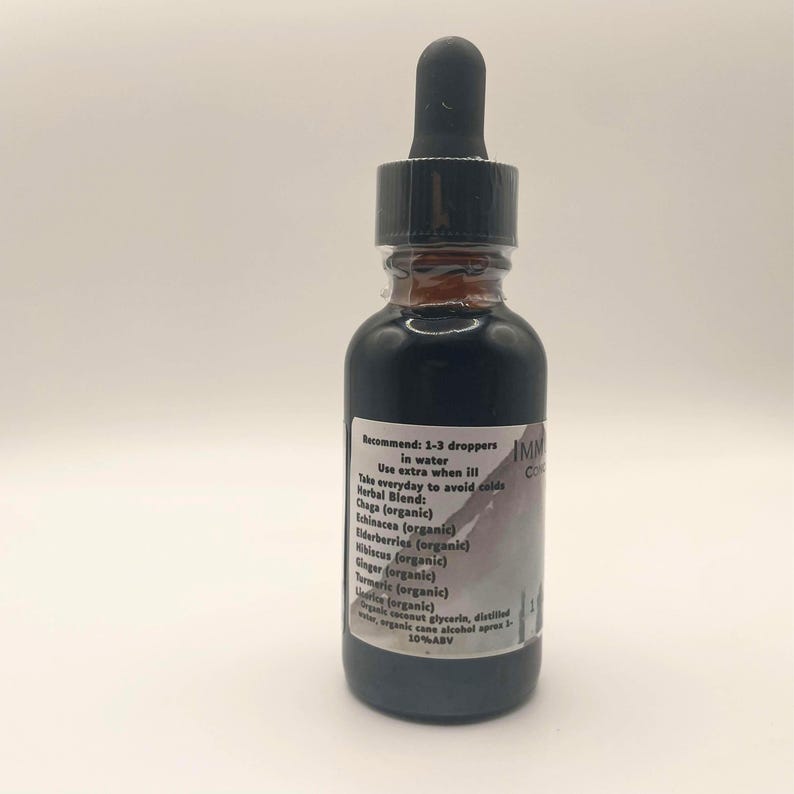 May include: A dark glass bottle with a black dropper top, filled with a dark liquid. A label on the bottle lists ingredients and usage instructions. The bottle is likely a herbal supplement or tincture.