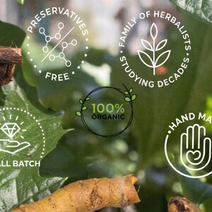 May include: Close-up of natural ingredients with text overlays. The image features turmeric roots, dark brown sticks, and green leaves. Text includes "Preservatives Free", "Family of Herbalists Studying Decades", "100% Organic", "Hand Made", and "Small Batch".