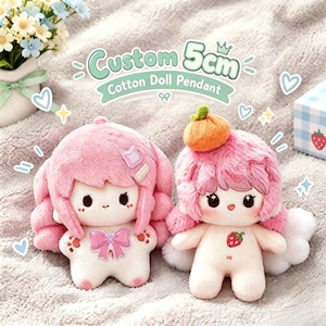 May include: Two plush cotton doll pendants measuring 5cm. The left doll has pink hair, a purple bow, and paw-print details. The right doll has pink hair, an orange hat, and a strawberry graphic on its chest. Both have embroidered facial features.