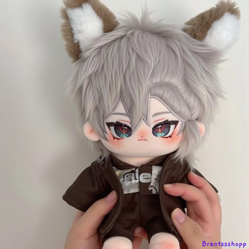 May include: A plush toy with grey hair and brown ears. The toy is wearing a brown jacket and pants. The toy has blue eyes and red blush.