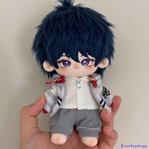May include: A plush toy with blue hair, wearing a white hoodie with a zipper, a gray and white striped jacket, and gray pants.