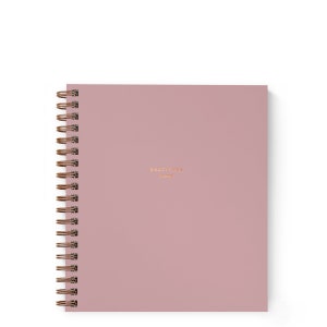May include: A dusty rose pink spiral bound journal with the words "Gratitude Journal" printed in gold on the front cover.