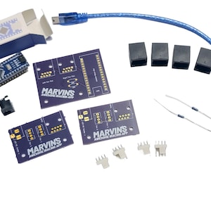 May include: An electronics DIY kit containing a blue microcontroller board in a box, three purple printed circuit boards labeled MARVIN'S AWESOME IRACING APP, a blue USB cable, four black RJ45 jacks, two DC power jacks, two resistors, and four white headers.