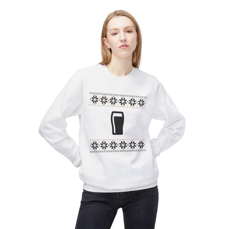Cozy holiday sweatshirt featuring a simple black pint glass design surrounded by festive knit-style snowflakes. Perfect for beer lovers, stout fans, and anyone who enjoys a classic winter look. Unisex white or gray sweatshirt with a soft, brushed interior and relaxed fit — ideal for Christmas parties, pub nights, or lounging by the fire. Eco-friendly materials and durable design for lasting comfort and holiday cheer. Keywords: guinness christmas sweater, beer lover gift, beer christmas gift