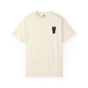 Unisex white t-shirt featuring a minimalist pint glass and the word “Sláinte,” meaning “health” in Irish, printed on the left chest. Perfect for St. Patrick’s Day, pub crawls, beer lovers, Guinness fans, and anyone who enjoys Irish culture. Made with soft garment-dyed cotton and a relaxed unisex fit, it’s a fun and comfortable drinking shirt for parties, casual outfits, and great as a gift for men and women who love beer and Ireland. Keywords: beer gift, beer shirt, guinness shirt, Irish pint