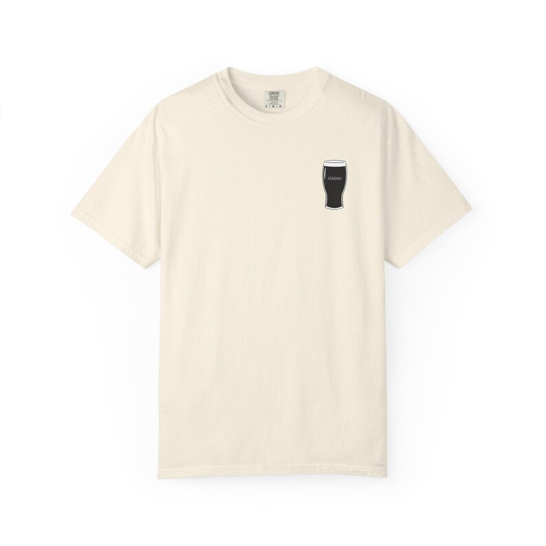 Unisex white t-shirt featuring a minimalist pint glass and the word “Sláinte,” meaning “health” in Irish, printed on the left chest. Perfect for St. Patrick’s Day, pub crawls, beer lovers, Guinness fans, and anyone who enjoys Irish culture. Made with soft garment-dyed cotton and a relaxed unisex fit, it’s a fun and comfortable drinking shirt for parties, casual outfits, and great as a gift for men and women who love beer and Ireland. Keywords: beer gift, beer shirt, guinness shirt, Irish pint