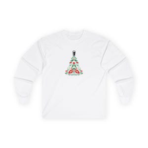 Unisex long sleeve Christmas shirt featuring a festive holiday tree topped with a pint glass. The design combines green and red holiday colors in a modern, minimal style — perfect for beer lovers and festive gatherings. Made from soft, eco-friendly cotton with a classic fit, this cozy long sleeve tee makes a fun and unique holiday gift for men and women who enjoy good cheer and winter comfort. Keywords: beer shirt, guinness christmas shirt, beer lover gift, christmas pint glass, guinness lover