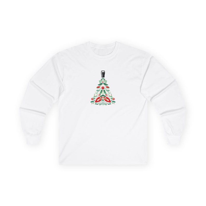 Unisex long sleeve Christmas shirt featuring a festive holiday tree topped with a pint glass. The design combines green and red holiday colors in a modern, minimal style — perfect for beer lovers and festive gatherings. Made from soft, eco-friendly cotton with a classic fit, this cozy long sleeve tee makes a fun and unique holiday gift for men and women who enjoy good cheer and winter comfort. Keywords: beer shirt, guinness christmas shirt, beer lover gift, christmas pint glass, guinness lover