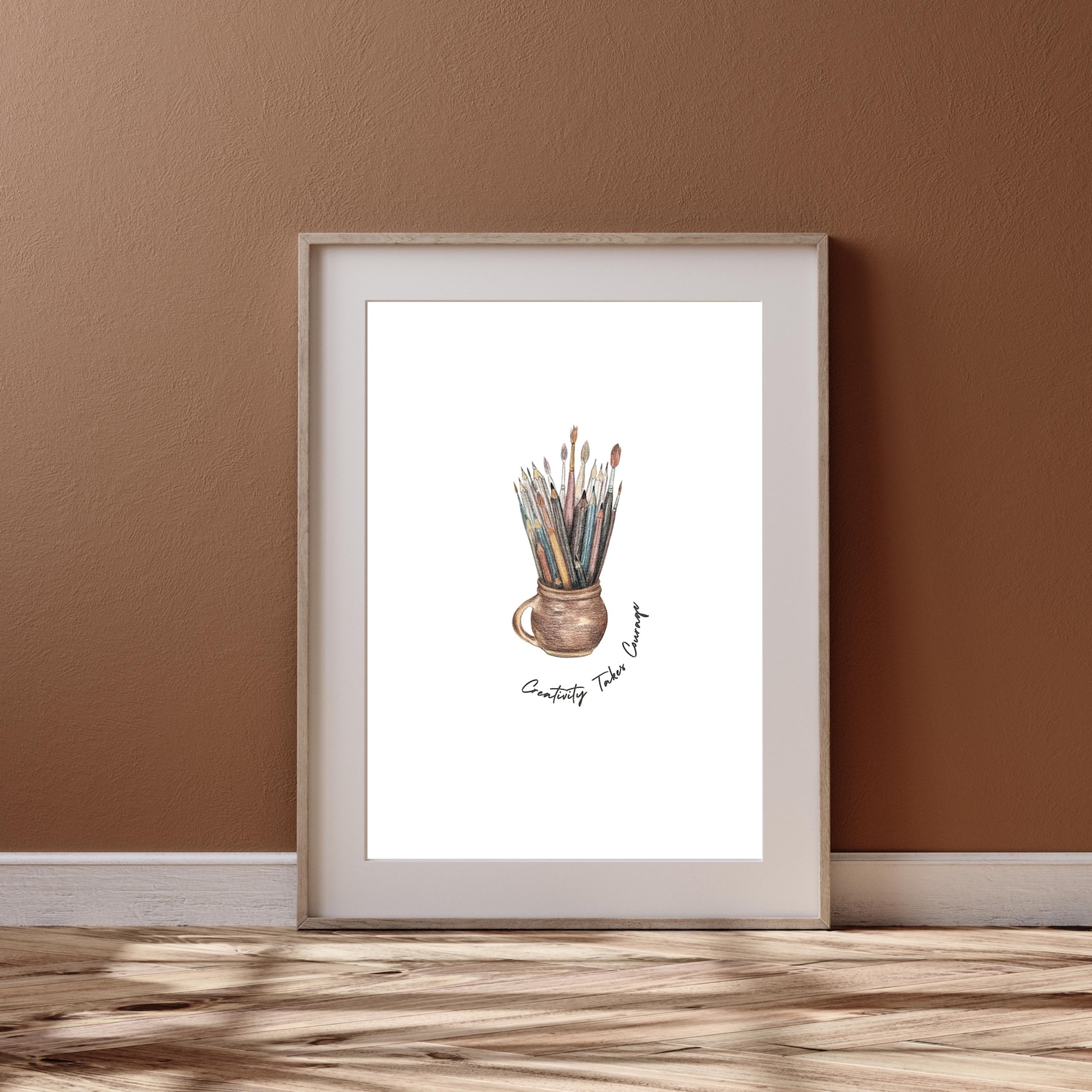 An inspirational art print with the words 'Creativity Takes Courage,' juxtaposing a vivid paint splatter to challenge the fear of an imperfect creative journey.