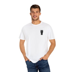 Unisex white t-shirt featuring a minimalist pint glass and the word “Sláinte,” meaning “health” in Irish, printed on the left chest. Perfect for St. Patrick’s Day, pub crawls, beer lovers, Guinness fans, and anyone who enjoys Irish culture. Made with soft garment-dyed cotton and a relaxed unisex fit, it’s a fun and comfortable drinking shirt for parties, casual outfits, and great as a gift for men and women who love beer and Ireland. Keywords: beer gift, beer shirt, guinness shirt, Irish pint